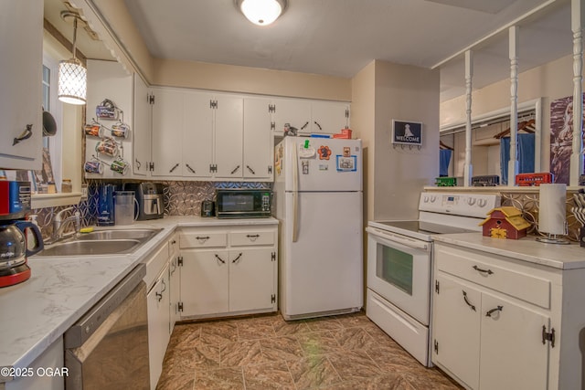 kitchen featuring backsplash, light countertops, white cabinets, white appliances, and a sink