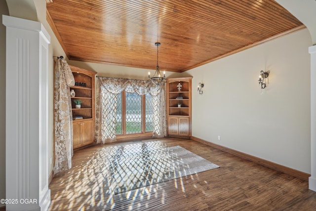 unfurnished dining area featuring wood ceiling and crown molding