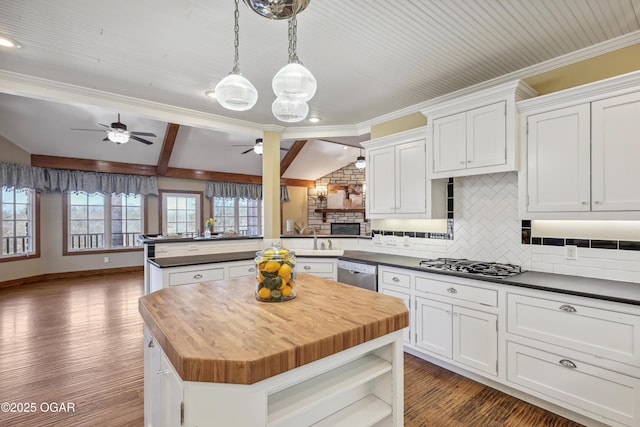 kitchen featuring tasteful backsplash, a kitchen island, stainless steel appliances, butcher block counters, and ceiling fan