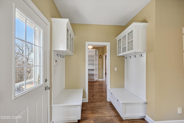 mudroom with dark wood-style floors and baseboards