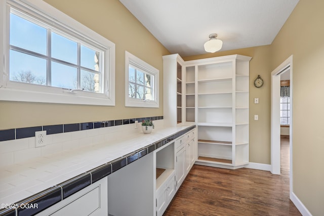 kitchen featuring baseboards, open shelves, dark wood-style flooring, tile counters, and white cabinets