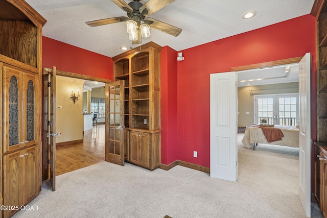 interior space with a ceiling fan, baseboards, carpet floors, recessed lighting, and french doors