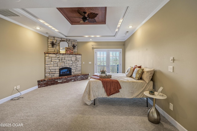 carpeted bedroom with crown molding, access to outside, visible vents, and a tray ceiling