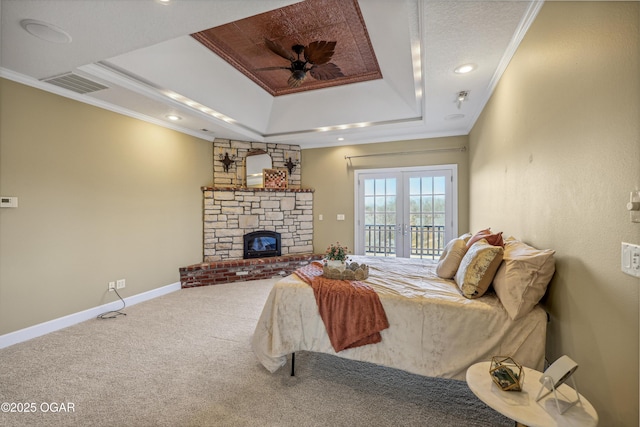 carpeted bedroom with baseboards, visible vents, a tray ceiling, ornamental molding, and access to outside