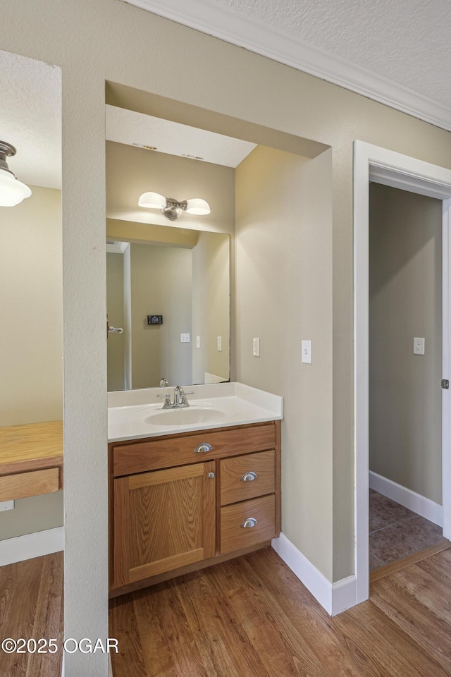 bathroom featuring a textured ceiling, wood finished floors, and vanity