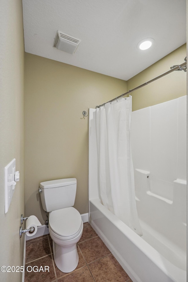 bathroom featuring tile patterned floors, visible vents, toilet, shower / bath combo, and baseboards