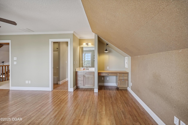 unfurnished bedroom featuring baseboards, ornamental molding, and light wood finished floors