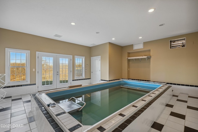 view of pool with a swimming pool, french doors, and an indoor hot tub