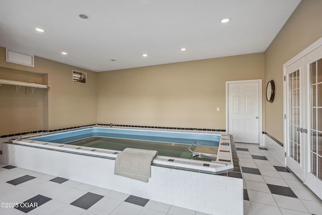 view of pool featuring french doors and a jacuzzi