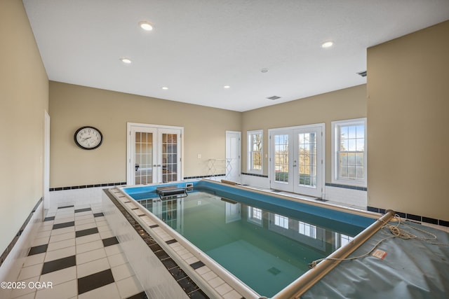 view of pool featuring french doors and a hot tub