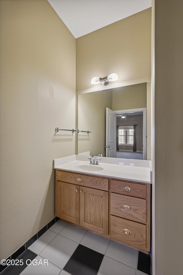 bathroom featuring tile patterned floors, vanity, and baseboards