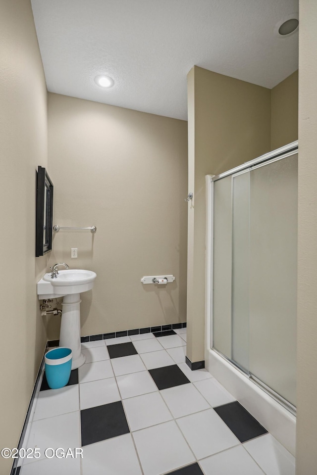 full bath with baseboards, a shower stall, and tile patterned flooring