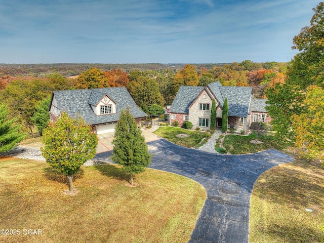 drone / aerial view featuring a forest view