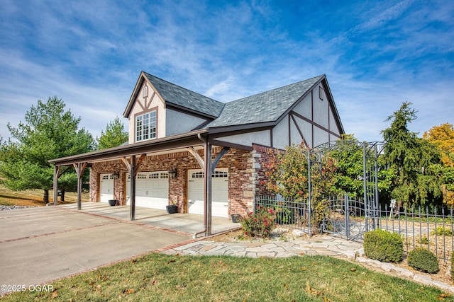 view of side of home featuring stucco siding, a garage, driveway, and fence