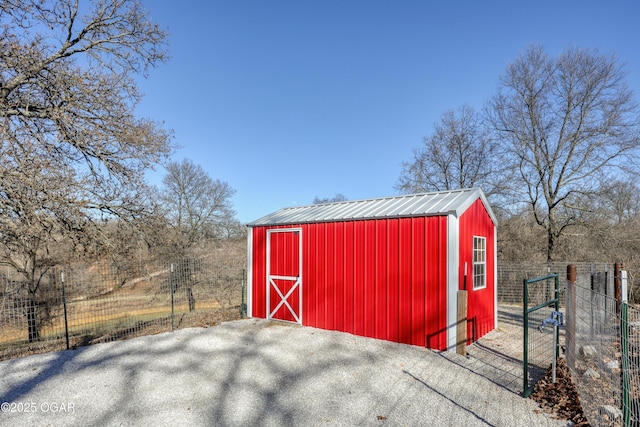 view of outbuilding with an outdoor structure and fence