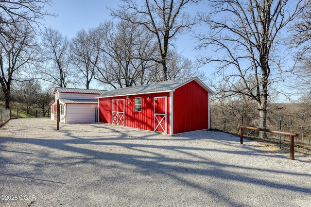 view of shed featuring fence