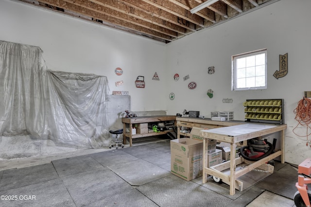 miscellaneous room with a workshop area and concrete floors