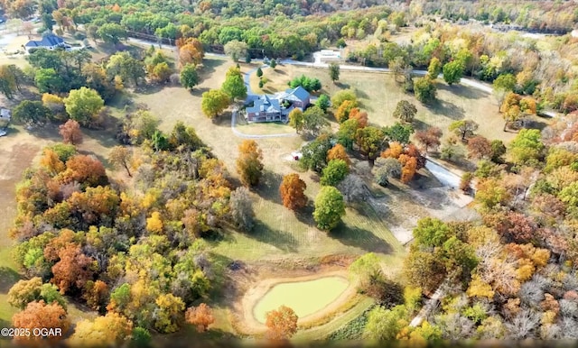 aerial view featuring a wooded view