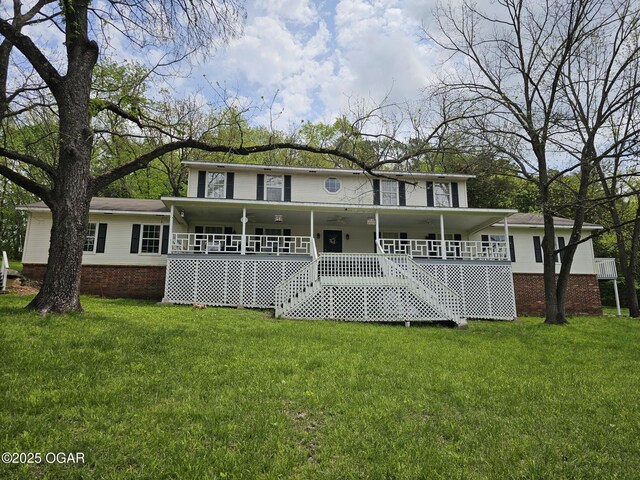 2332 Packet Hollow Rd, Pineville, MO 64856 - back of house with a lawn, stairs, and a porch