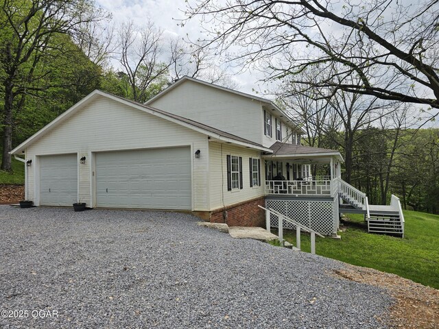 2332 Packet Hollow Rd, Pineville, MO 64856 - view of front facade featuring stairway, a porch, and a garage