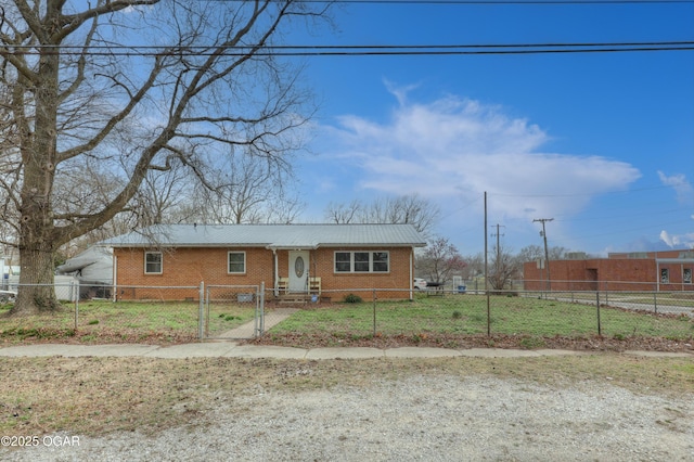 view of front of house featuring a fenced front yard, brick siding, metal roof, and a gate