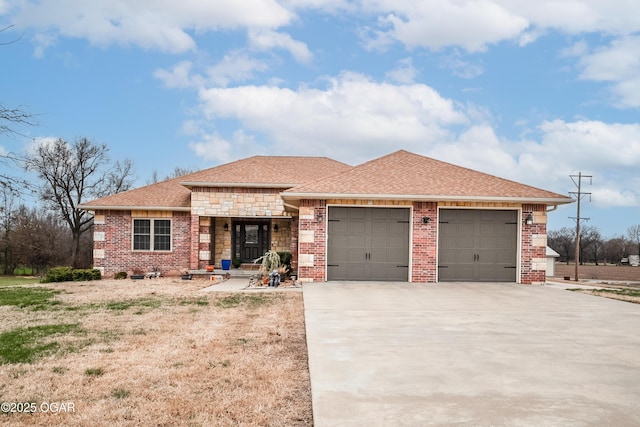 view of front facade with driveway, stone siding, an attached garage, a shingled roof, and brick siding
