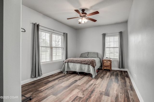 bedroom with ceiling fan, baseboards, and wood finished floors