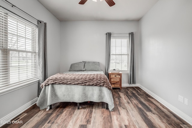 bedroom with ceiling fan, baseboards, and wood finished floors