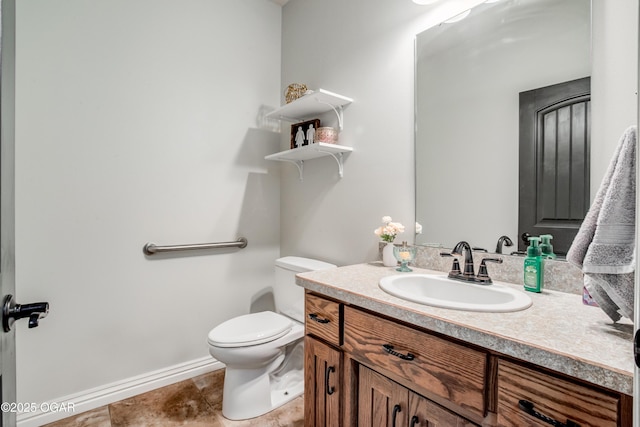 bathroom featuring tile patterned floors, toilet, vanity, and baseboards
