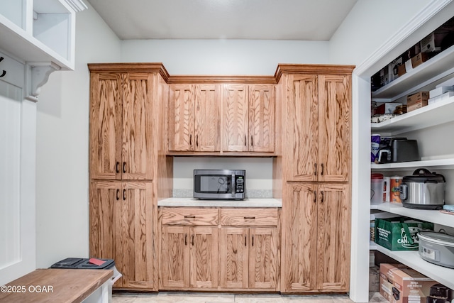 kitchen with stainless steel microwave and light countertops
