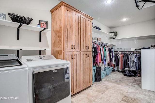 clothes washing area with recessed lighting, cabinet space, and washer and clothes dryer