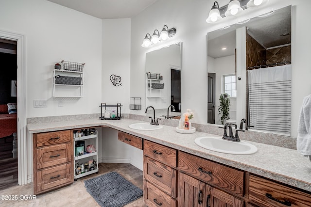 full bathroom featuring double vanity, tile patterned flooring, curtained shower, and a sink