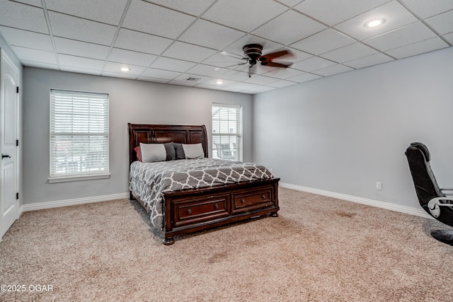 bedroom featuring carpet, baseboards, and a paneled ceiling