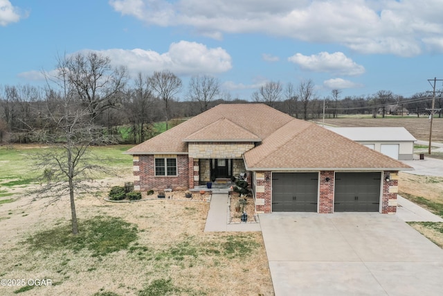 view of front of property with brick siding, roof with shingles, concrete driveway, and an attached garage