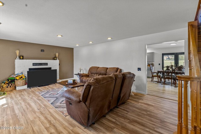 9426 Business 60, Monett, MO 65708 - living room with recessed lighting, a fireplace with raised hearth, baseboards, and wood finished floors