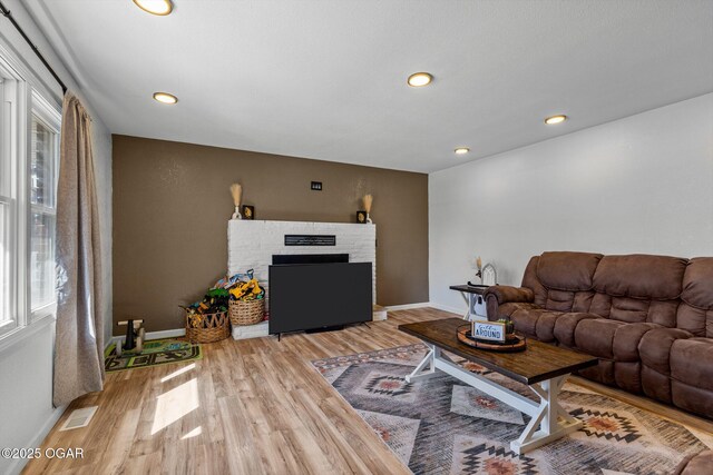 9426 Business 60, Monett, MO 65708 - living room with baseboards, visible vents, wood finished floors, and a fireplace