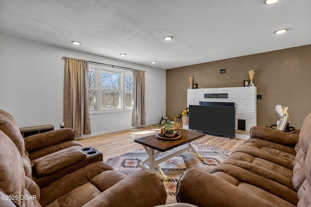 9426 Business 60, Monett, MO 65708 - living room featuring visible vents, baseboards, a fireplace, recessed lighting, and light wood-type flooring
