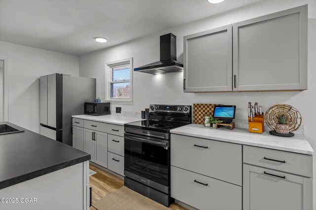 9426 Business 60, Monett, MO 65708 - kitchen with light countertops, light wood-style flooring, appliances with stainless steel finishes, and wall chimney exhaust hood