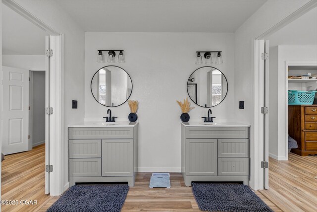 9426 Business 60, Monett, MO 65708 - ensuite bathroom with ensuite bathroom, wood finished floors, two vanities, and a sink