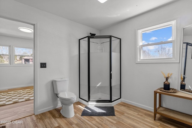 9426 Business 60, Monett, MO 65708 - full bathroom featuring a stall shower, toilet, wood finished floors, and baseboards