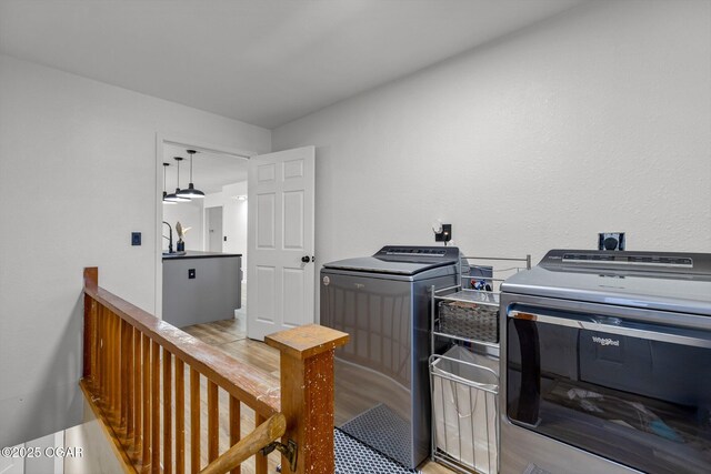9426 Business 60, Monett, MO 65708 - laundry area featuring washing machine and clothes dryer, laundry area, and light wood-style flooring