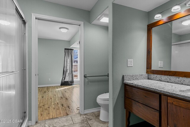 9426 Business 60, Monett, MO 65708 - full bath with vanity, toilet, a shower with door, baseboards, and tile patterned floors