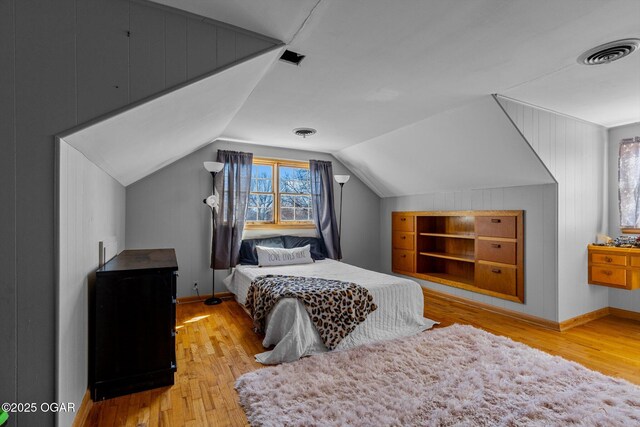 9426 Business 60, Monett, MO 65708 - bedroom featuring baseboards, lofted ceiling, visible vents, and wood-type flooring