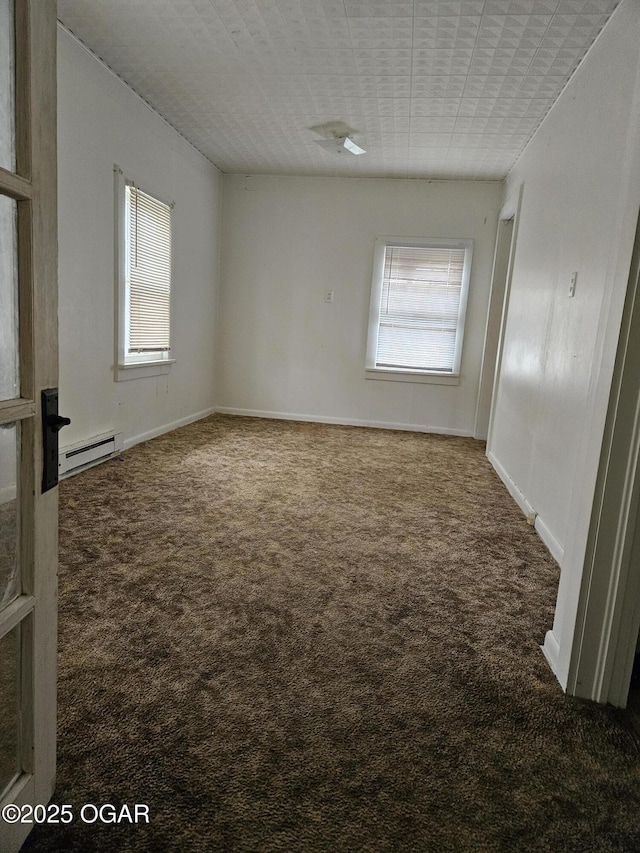 906 Randolph St, Neosho, MO 64850 - carpeted empty room featuring baseboards and a baseboard heating unit