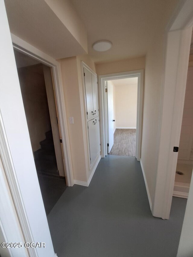 514 S Cole, Granby, MO 64844 - hallway featuring finished concrete flooring, baseboards, and stairs