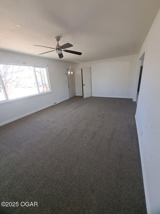 514 S Cole, Granby, MO 64844 - spare room with baseboards, visible vents, ceiling fan, and dark carpet