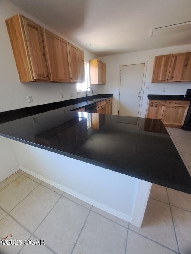 514 S Cole, Granby, MO 64844 - kitchen featuring light tile patterned flooring, dark countertops, and a peninsula