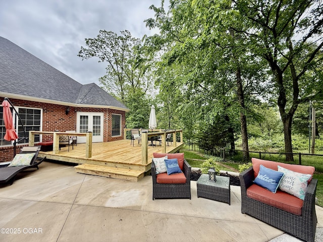 view of patio / terrace featuring a wooden deck, outdoor dining space, outdoor lounge area, and fence