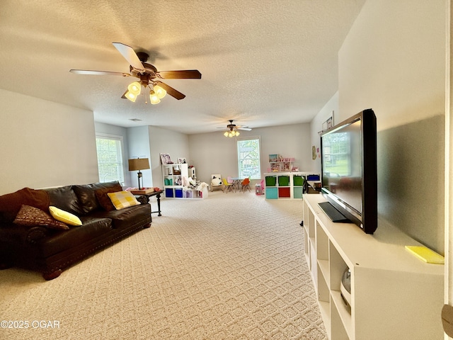 game room with carpet flooring, ceiling fan, a textured ceiling, and plenty of natural light