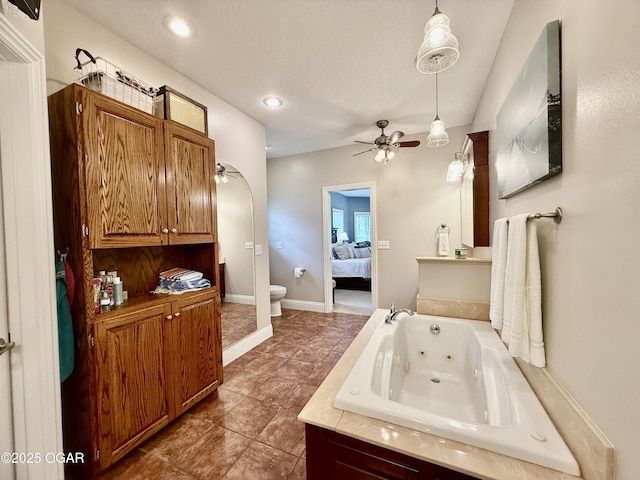 bathroom featuring connected bathroom, a ceiling fan, toilet, a tub with jets, and vanity